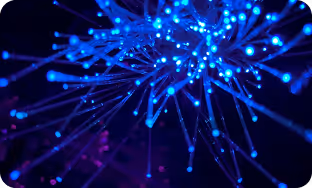 Close-up of blue fiber optic lights glowing in a dark setting.