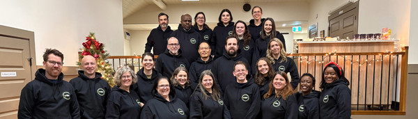 The FH Canada staff team gathered together in matching hoodies at the office