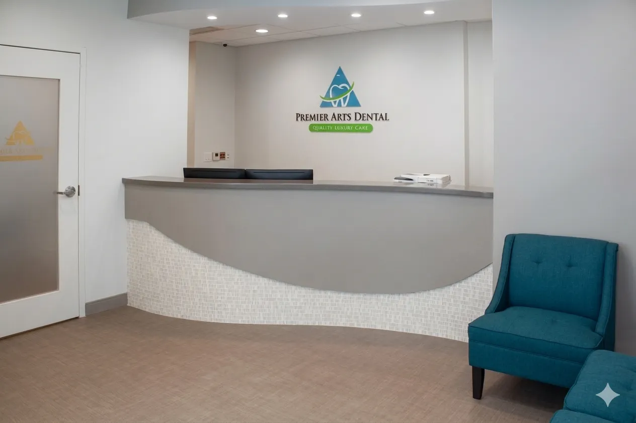 Reception area of Premier Arts Dental with a modern desk and teal chairs.