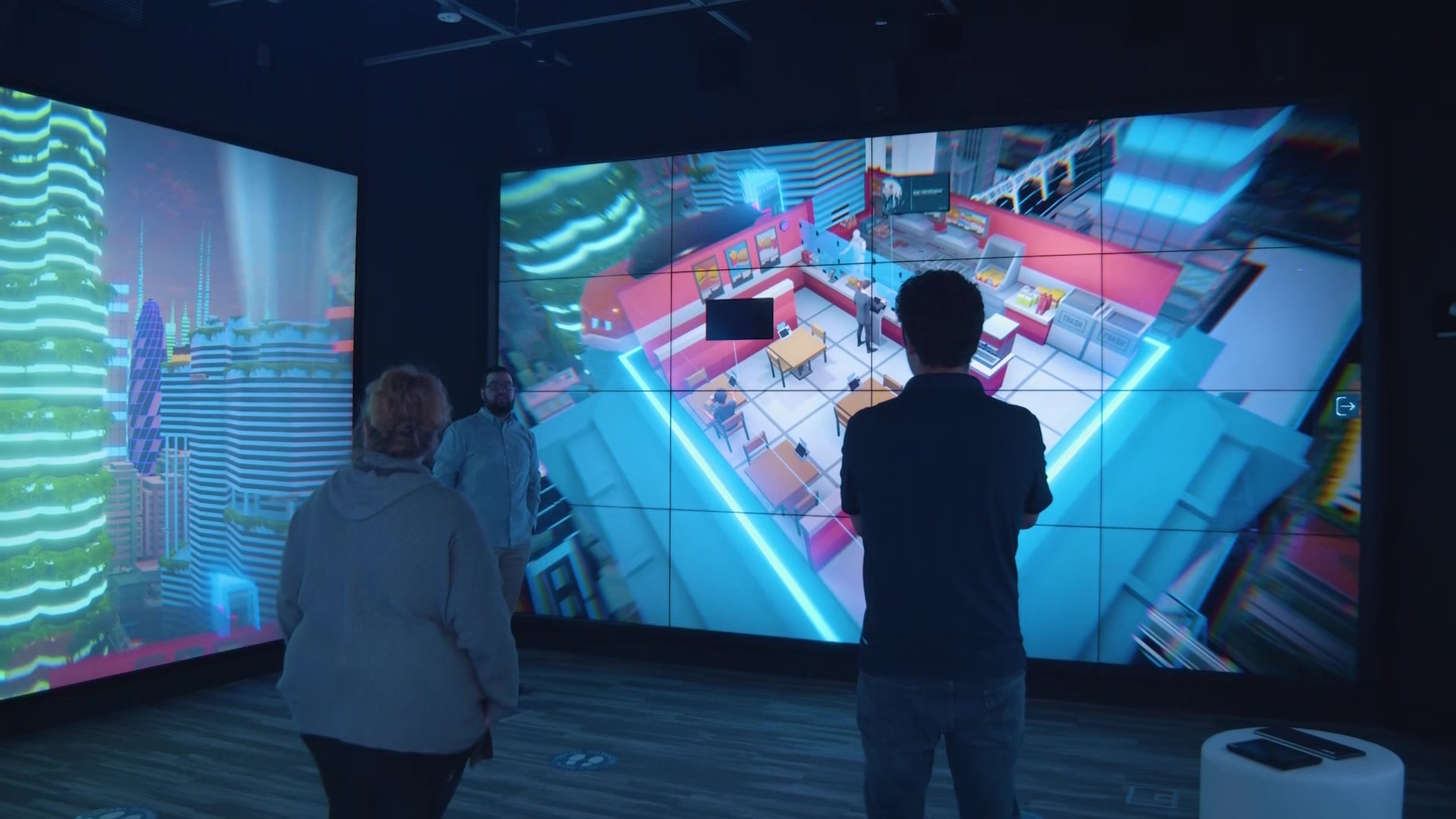 People exploring NTT DATA’s virtual environments on the immersive room’s surrounding screens