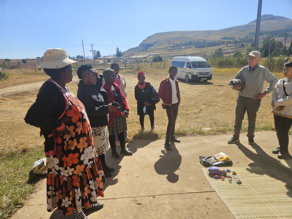 Cebisile displays her handwoven icansi mats and crafts to visitors in Bergville, South Africa