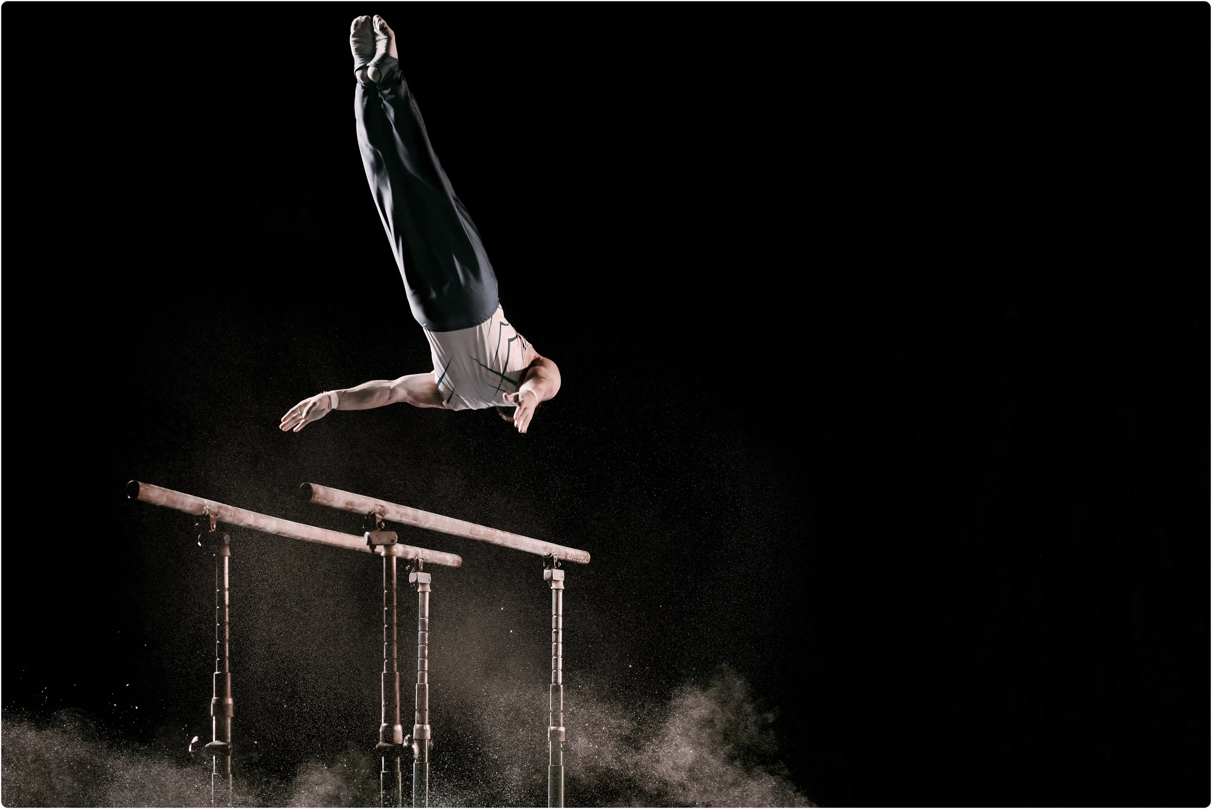 Male gymnast on parallel bars during training