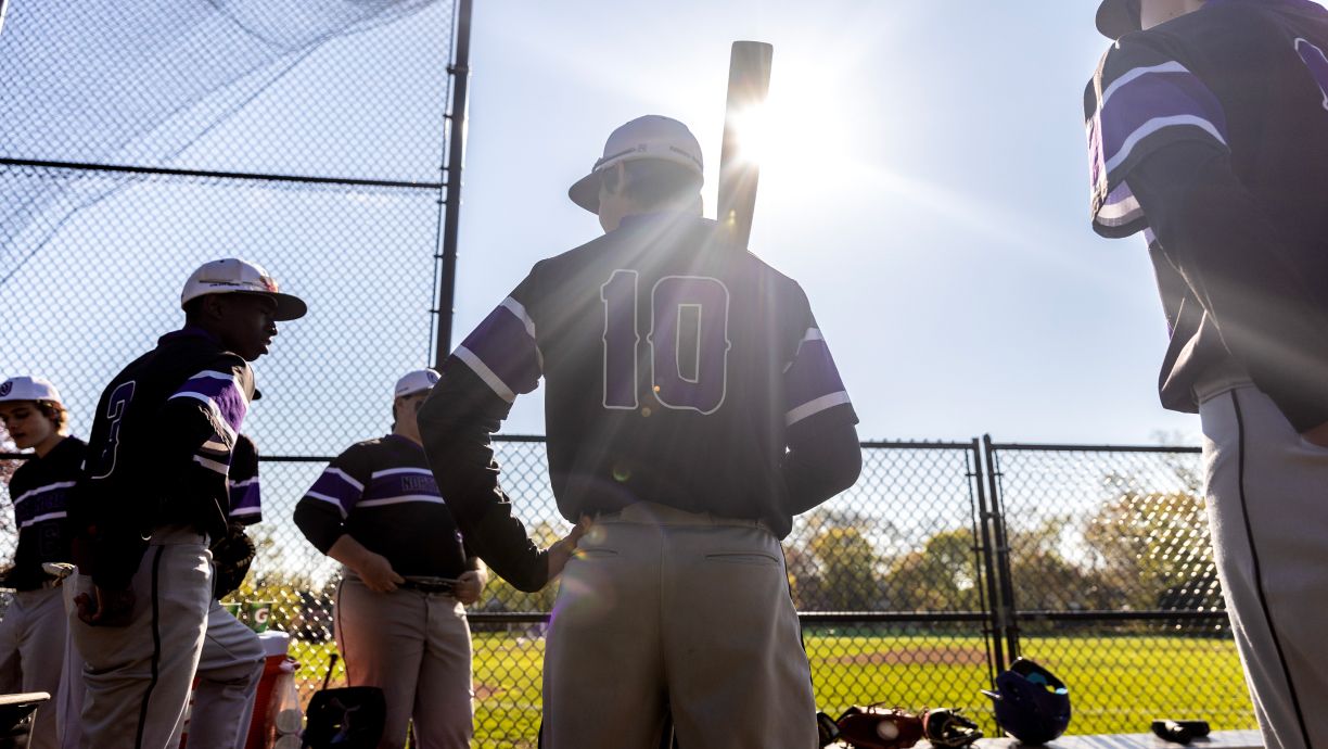 North Shore Country Day School (IL) baseball players waiting for the game to begin on a sunny day.