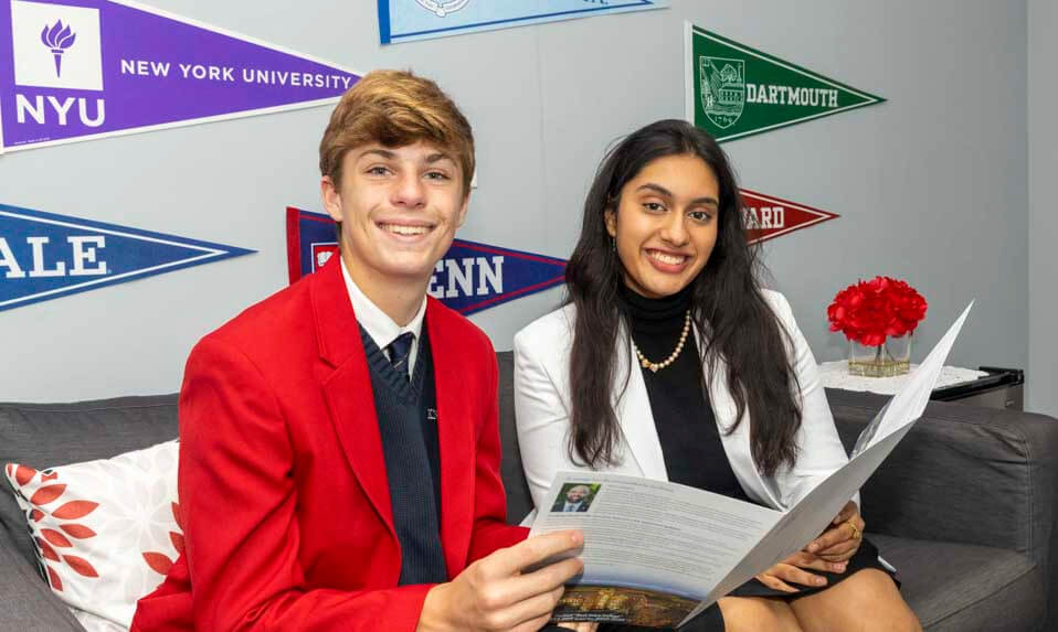 A Knox Student looking at a college brochure with his counselor.