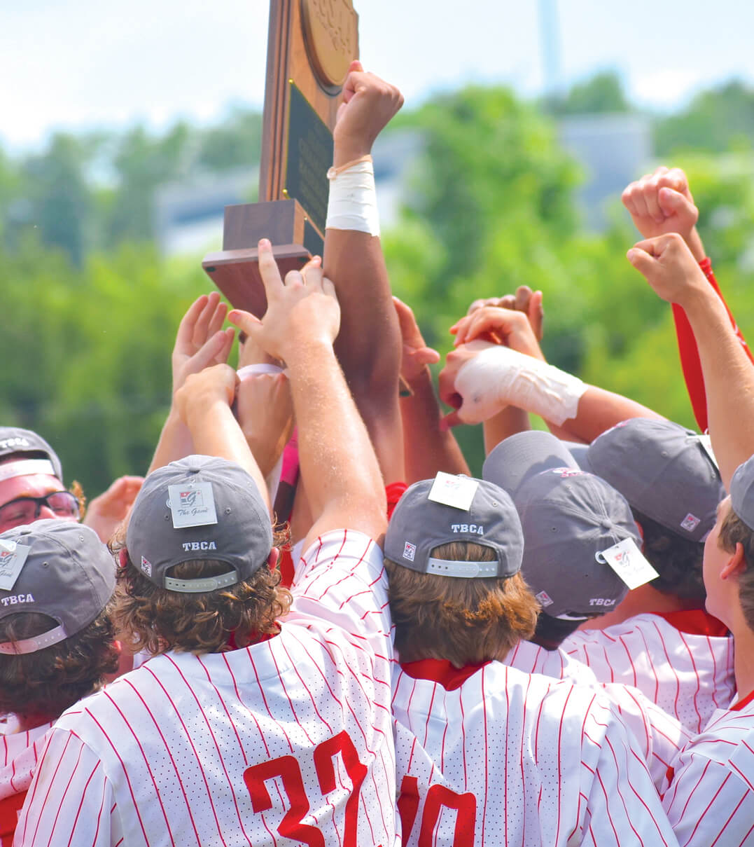 The Baylor School baseball team holding up a trophy after winning the championship.