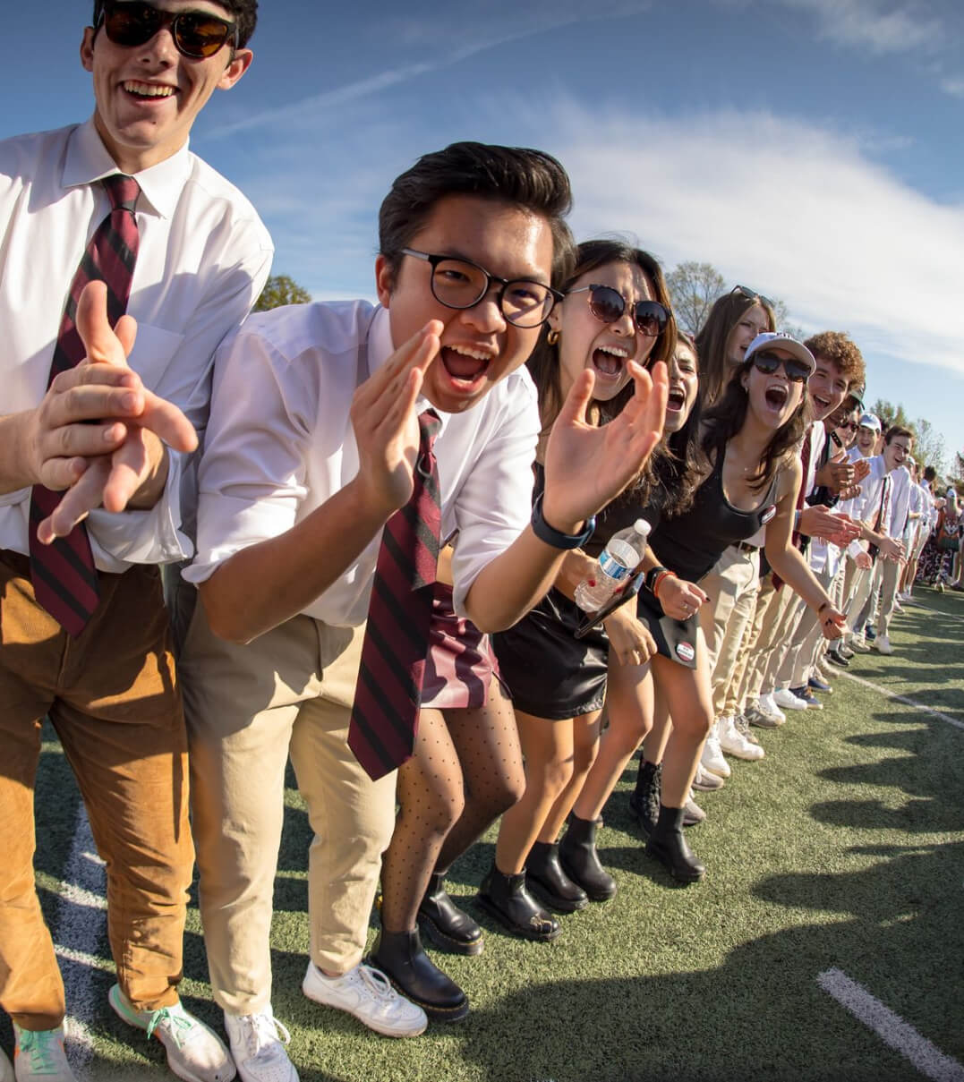 Episcopal High School students in a spirit line cheering on their schoolmates.