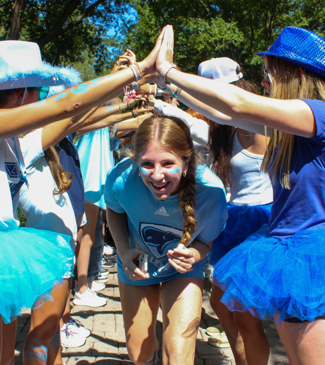 A Garrison Forest School student running through a hand tunnel.
