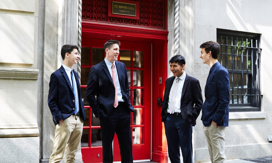 Students at The Browning School talking outside of the school entrance.