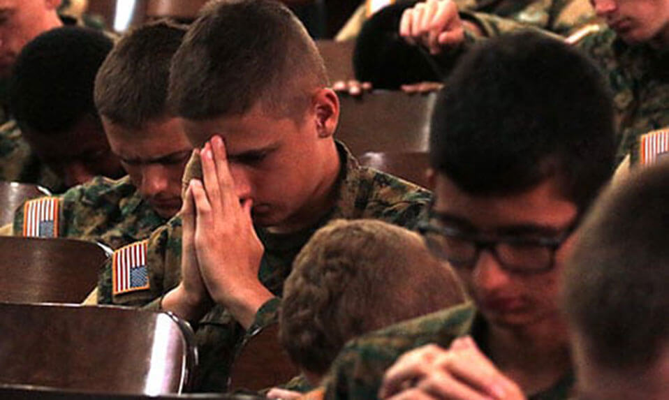 Fork Union Military Academy cadets praying during a religious service.