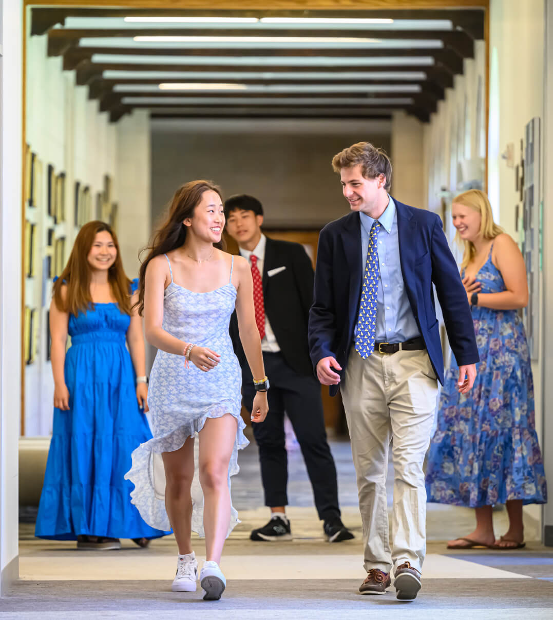 Two St. Mark's students walking down the hall and laughing.