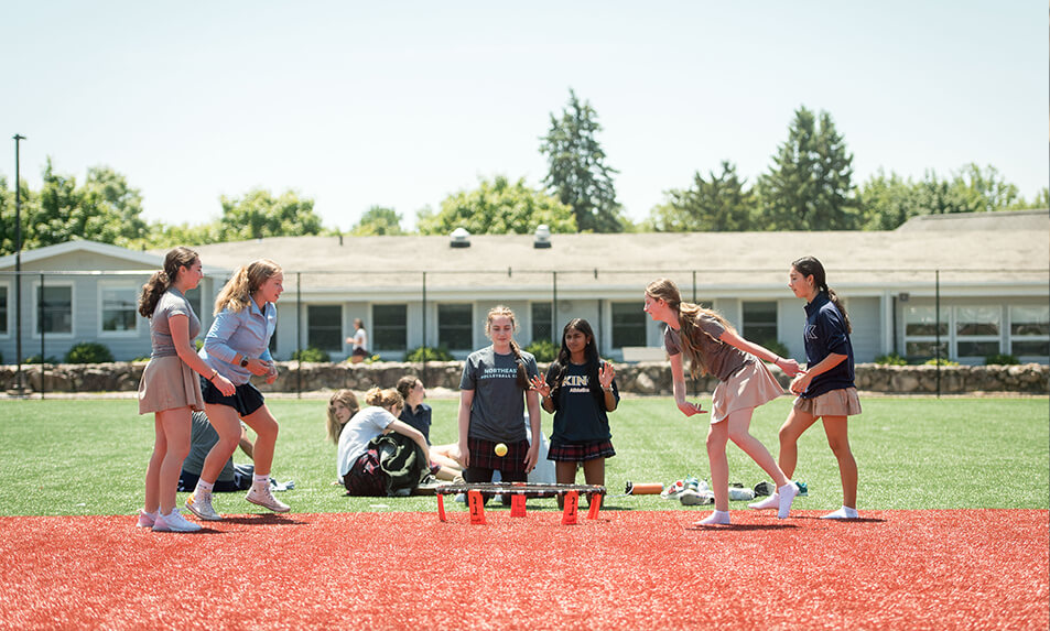 A group of female King School students outside playing trampoline ball.