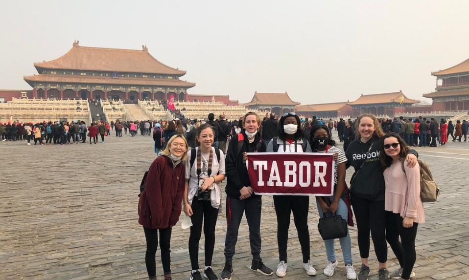 Students holding up a Tabor banner in China.