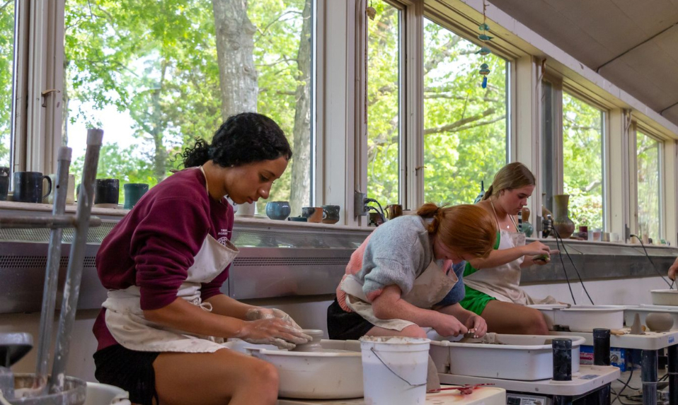 Tabor students working the pottery wheels.