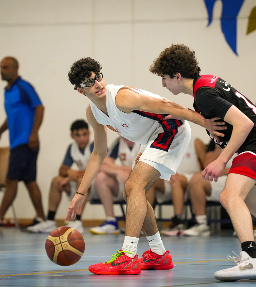 King's Academy students playing basketball.