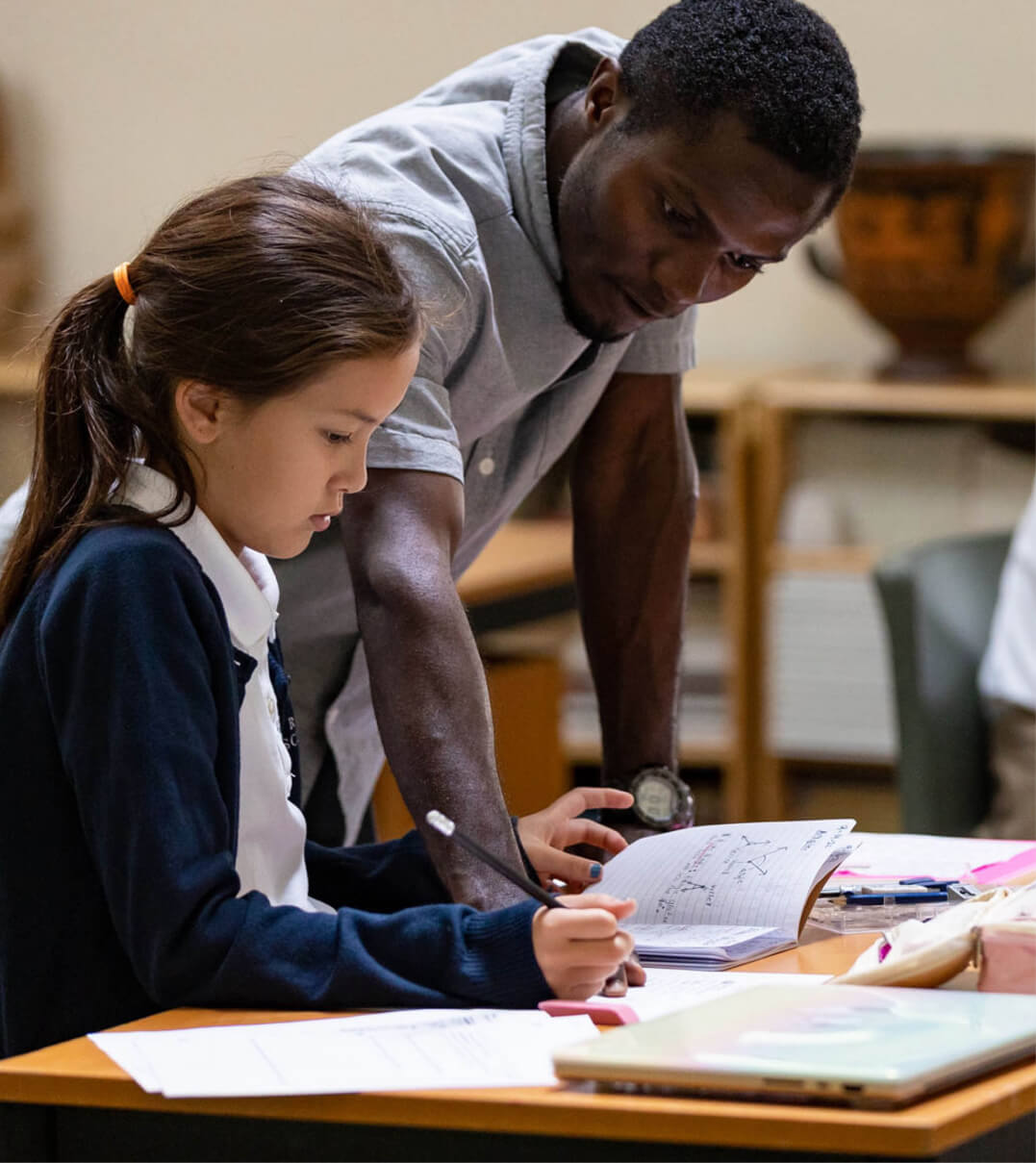 A Ross School teacher helping a student.