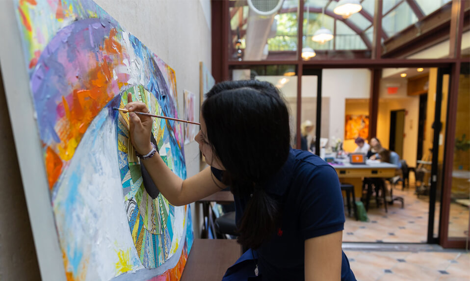 A Ross School art student painting.