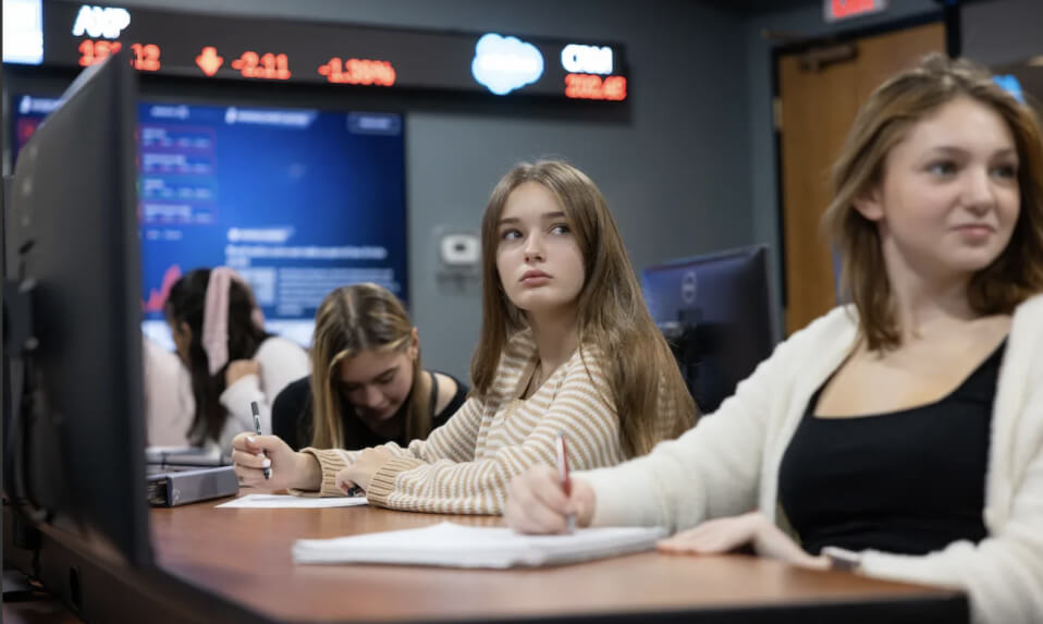 WMA students watching a stock ticker in the school's Trading Center.