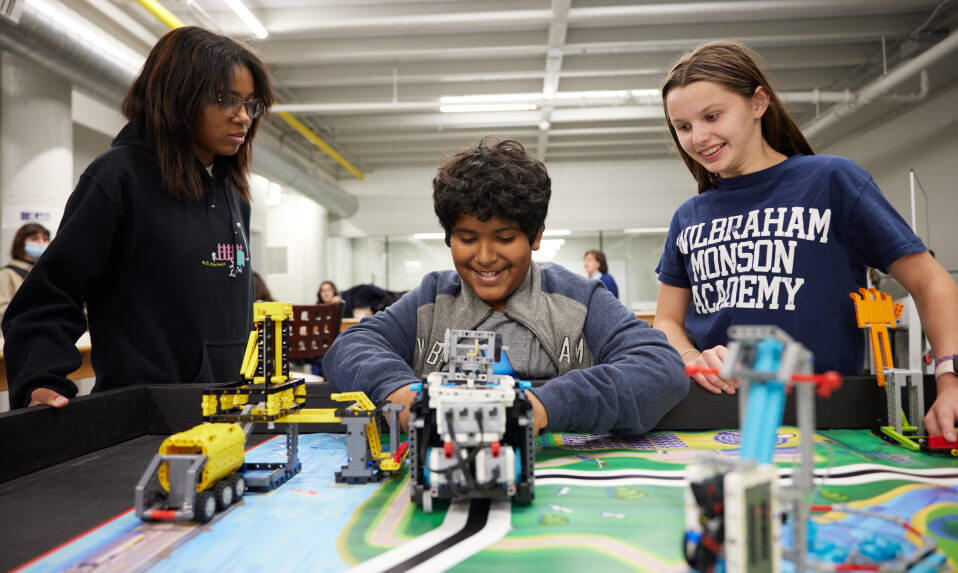 WMA middle school students working in a robotics bay.