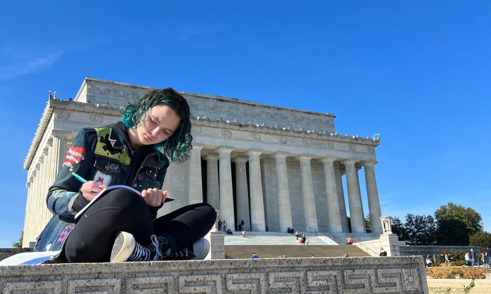 An Episcopal High School (VA) students draws in her sketchbook outside of the Lincoln Memorial.