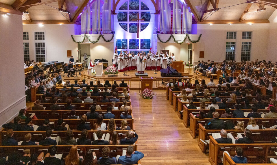 A chapel service at Episcopal High School (VA) with students in pews and the choir singing at the front.