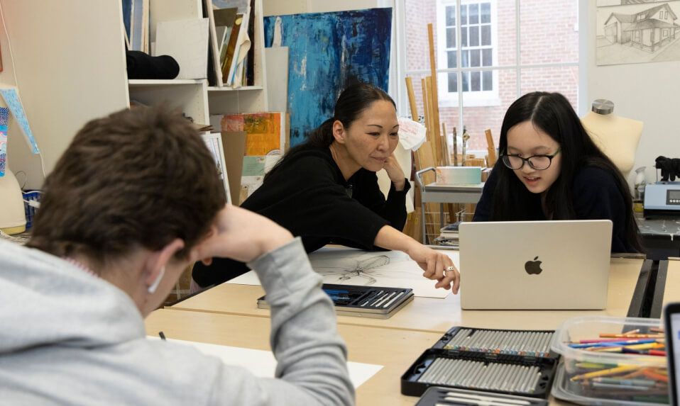 An Episcopal High School (VA) art teacher providing a student feedback on her work.