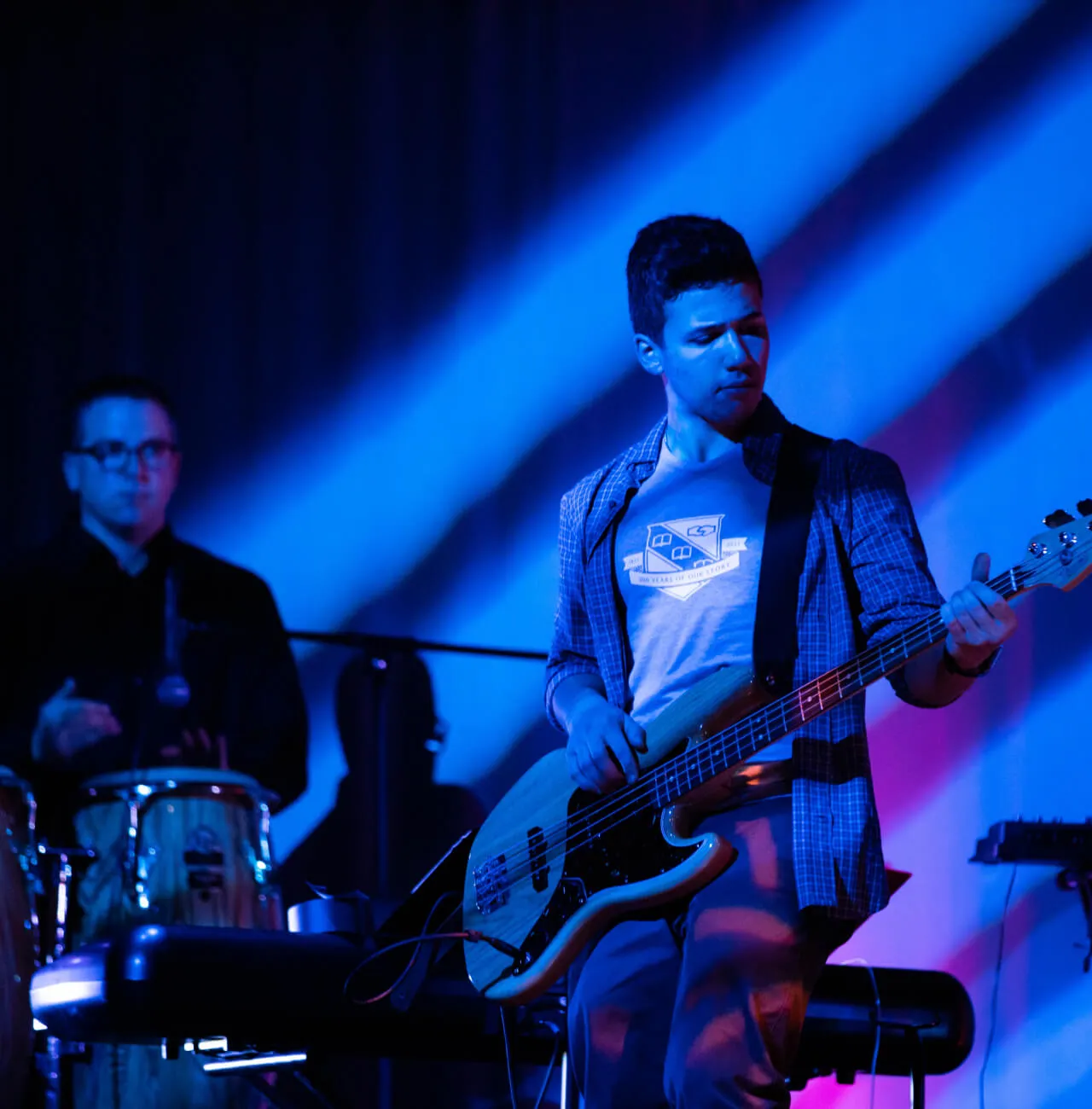 A New Hampton School student playing the guitar during a concert.