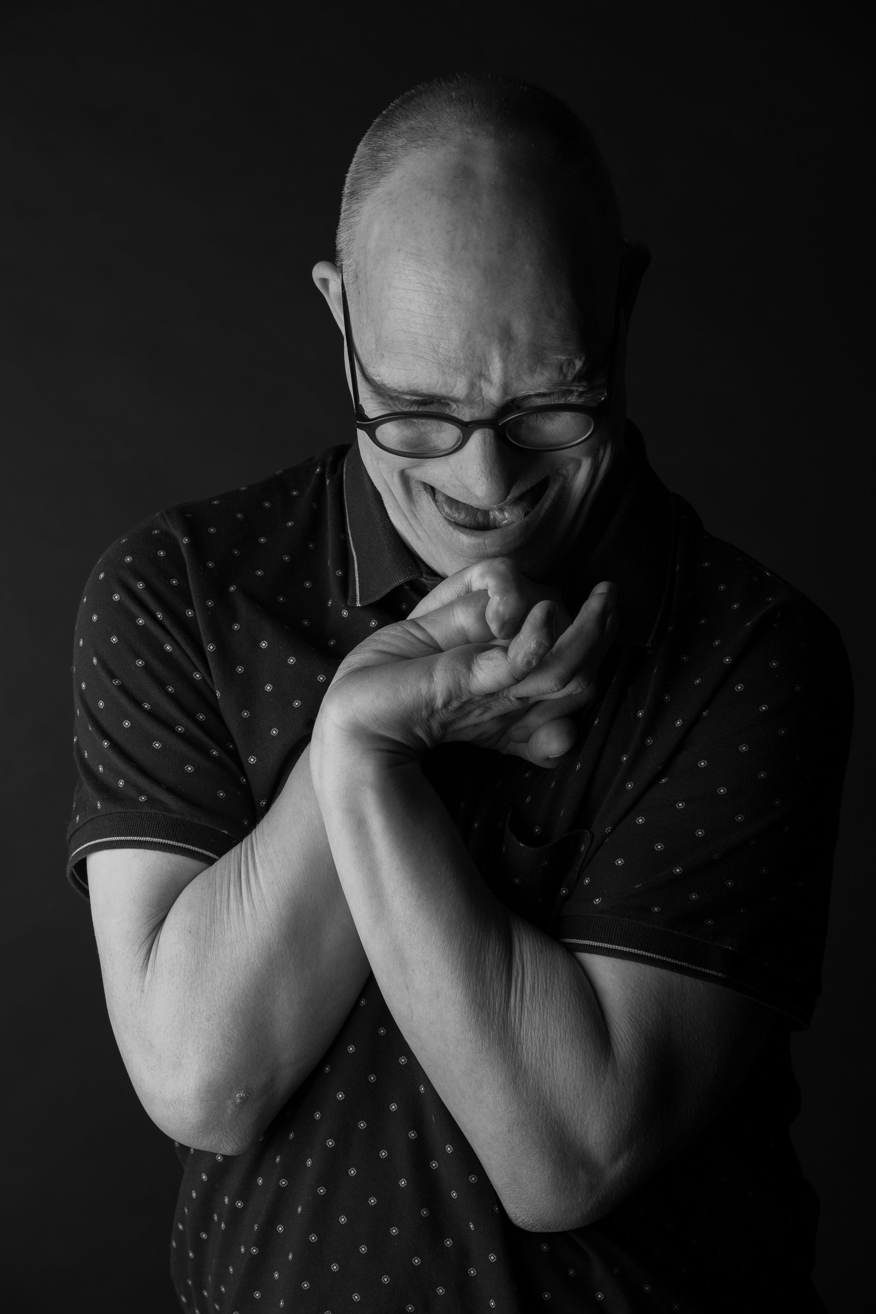 Willem laughing with his hands folded under his chin