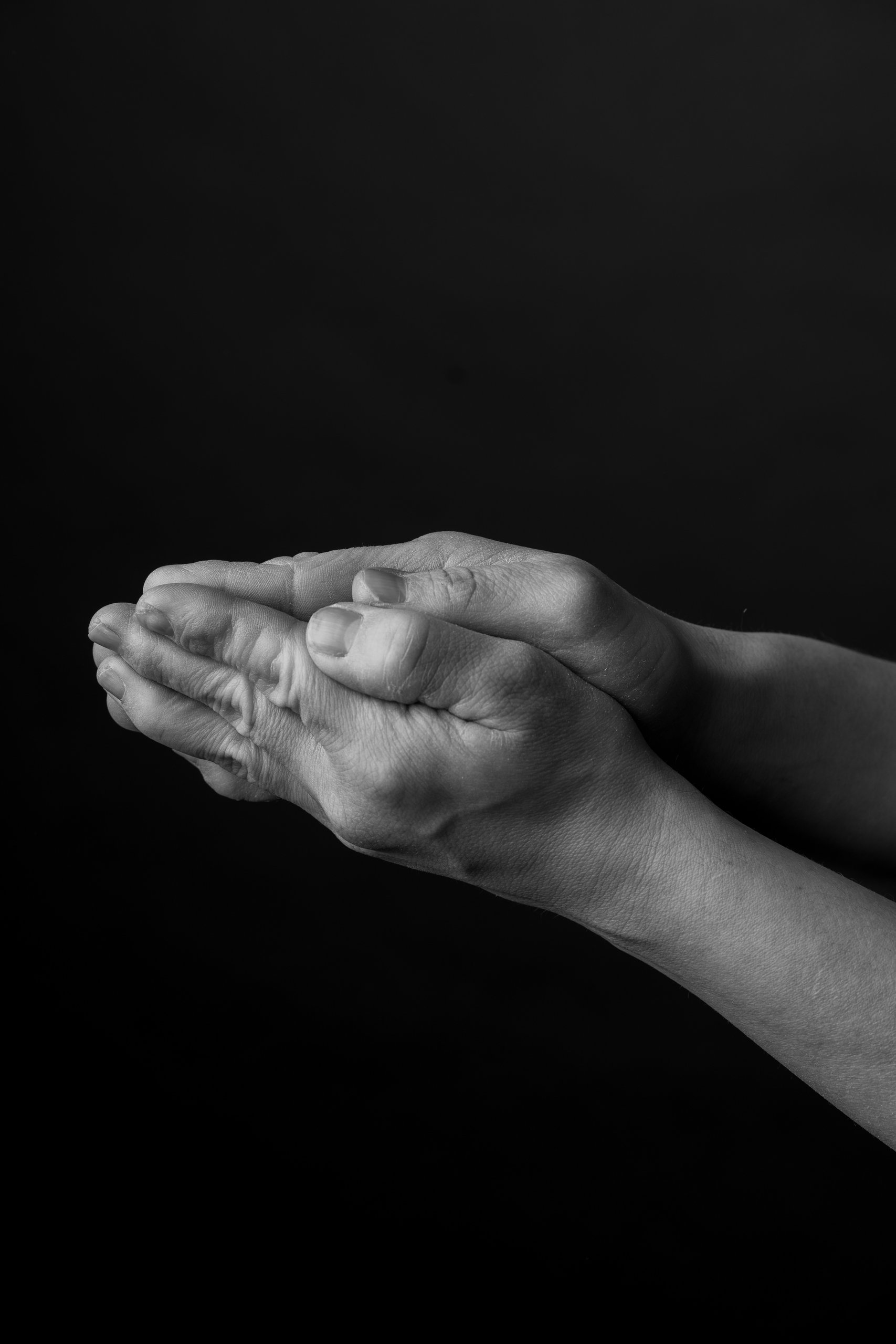 Cupped hands held together, black and white close-up