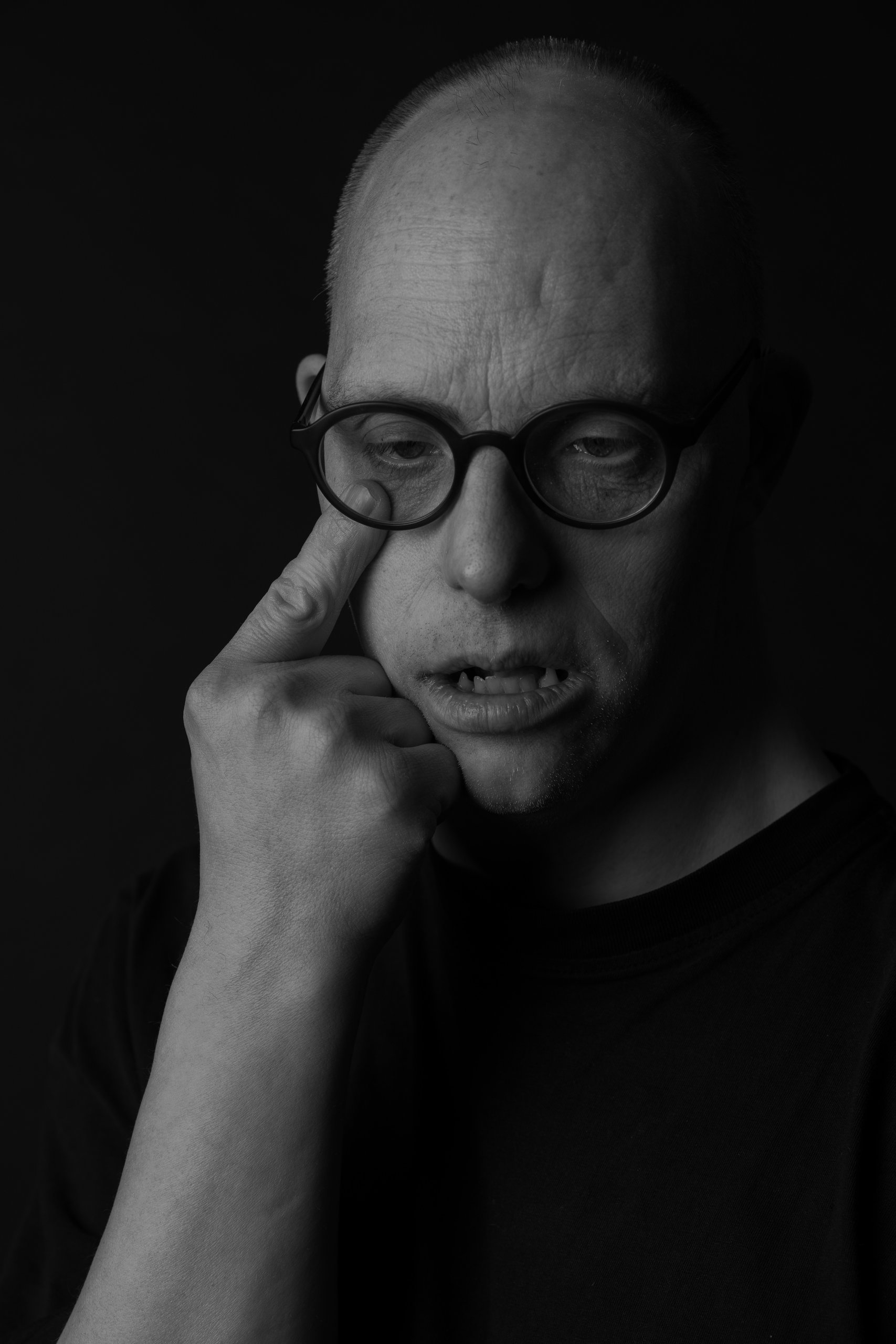 Close portrait of Willem, finger resting under his eye