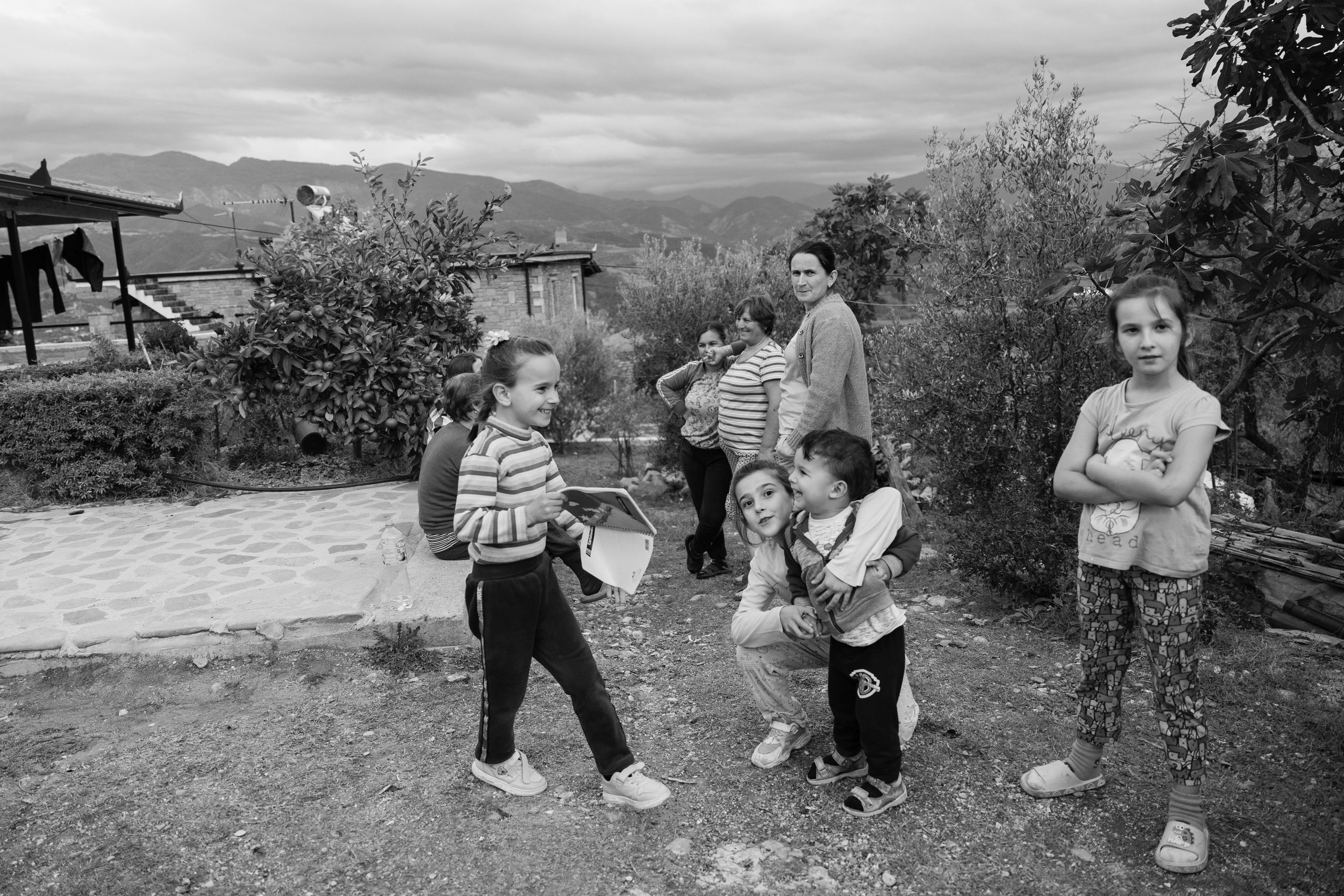 Three generations of a family gathered in their garden in rural Albania