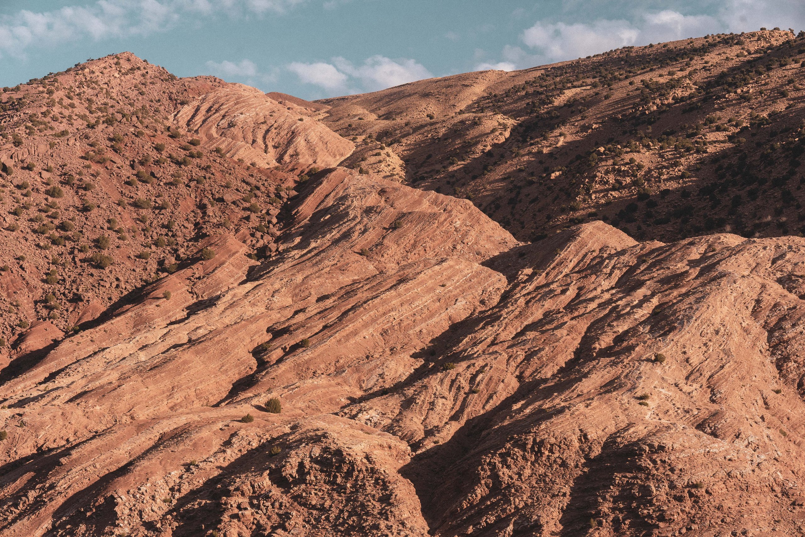 Folded red rock slopes of the Atlas Mountains, Morocco