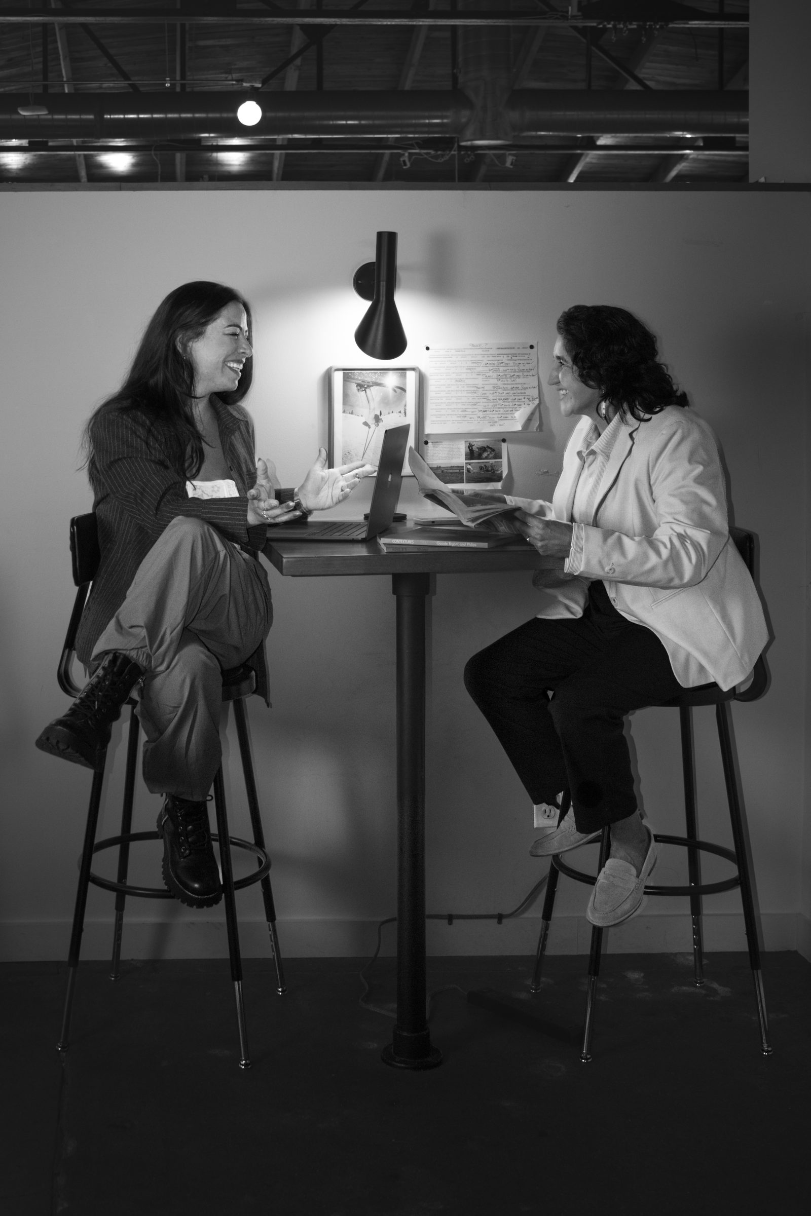 Two strategists at a high table, black and white.