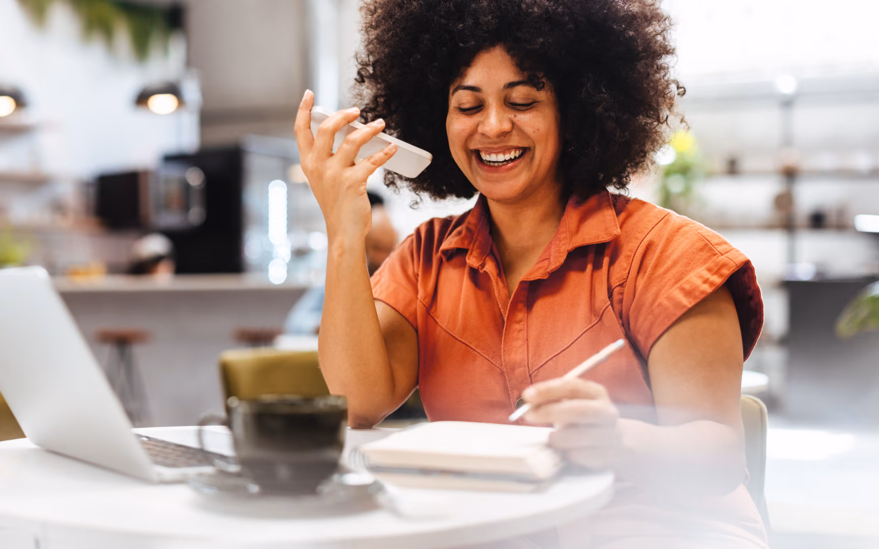 Woman talking on phone and writing stock image