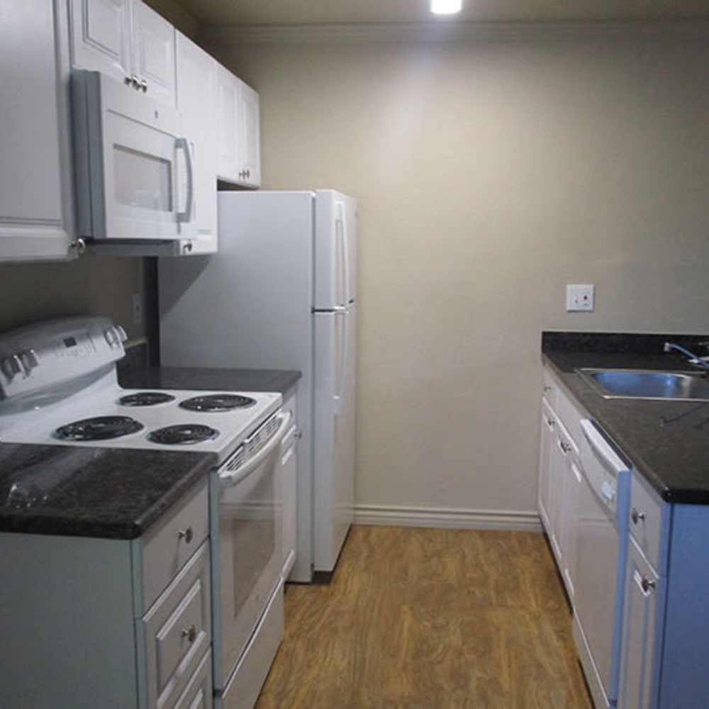 Kitchen with white cabinets and white appliances