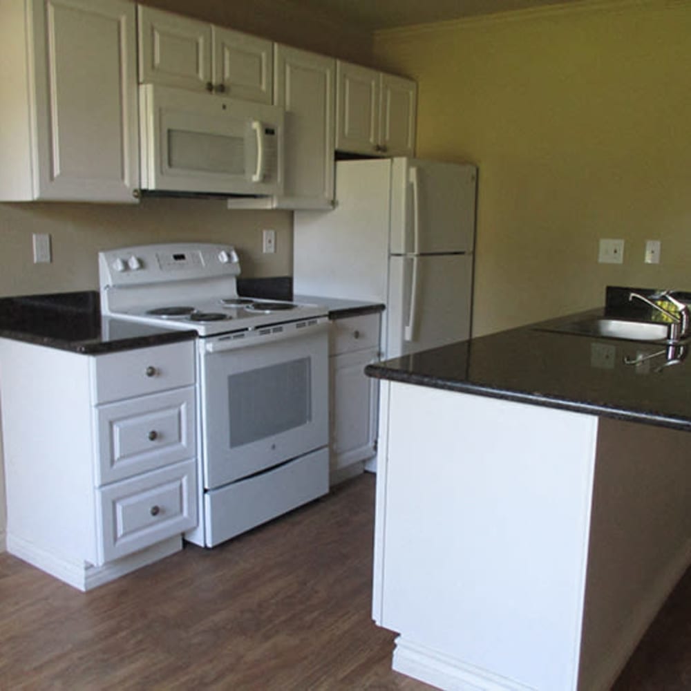 Kitchen with white cabinets and white appliances