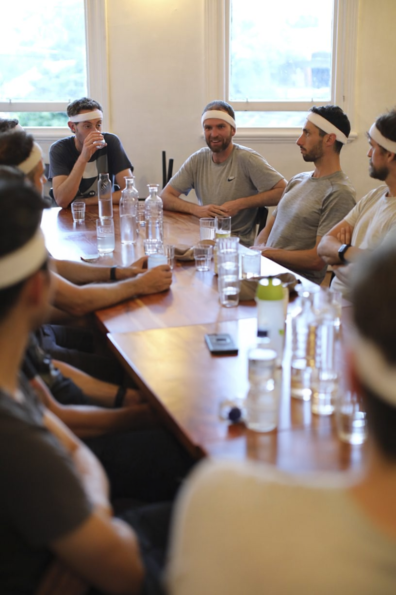 Dads talking together around a table at a Dadfit session