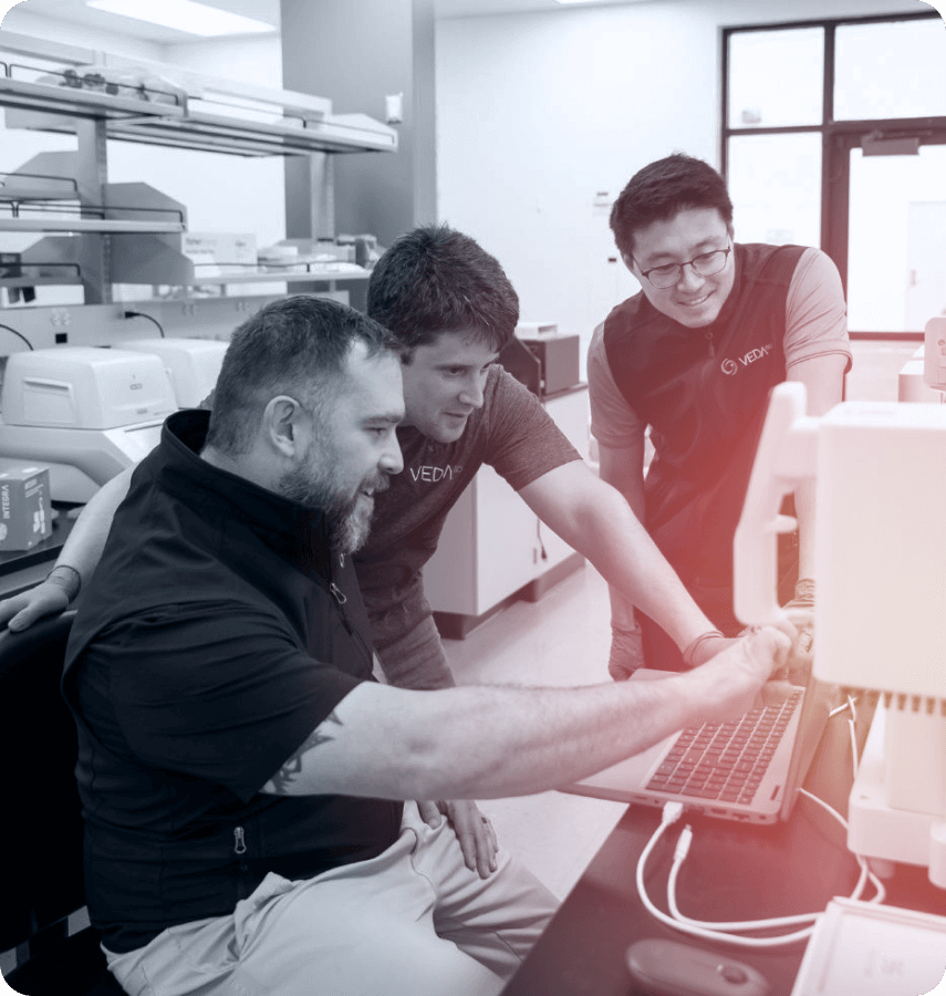 Vedabio team members collaborating in a laboratory environment