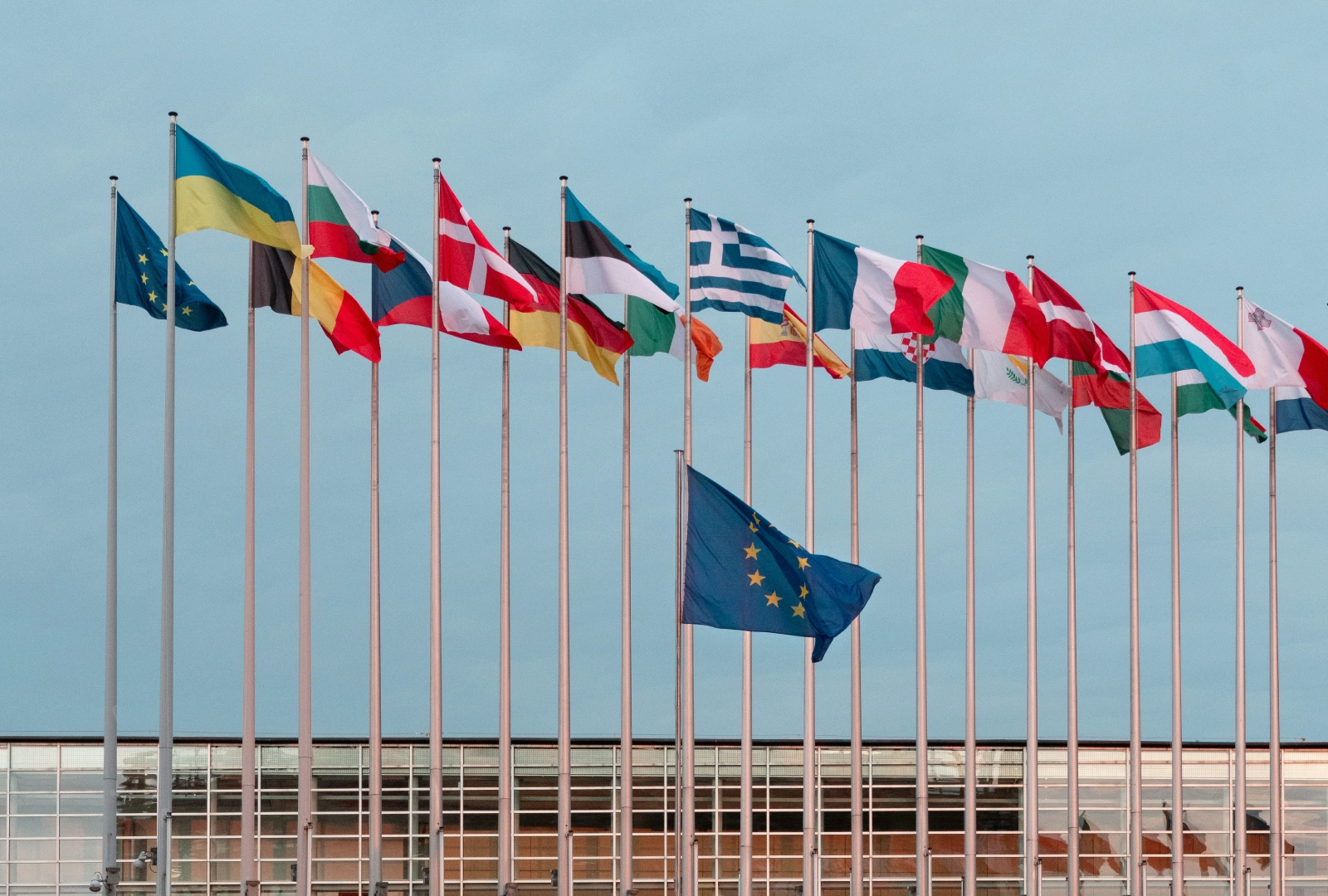 European flags flying outside a modern building