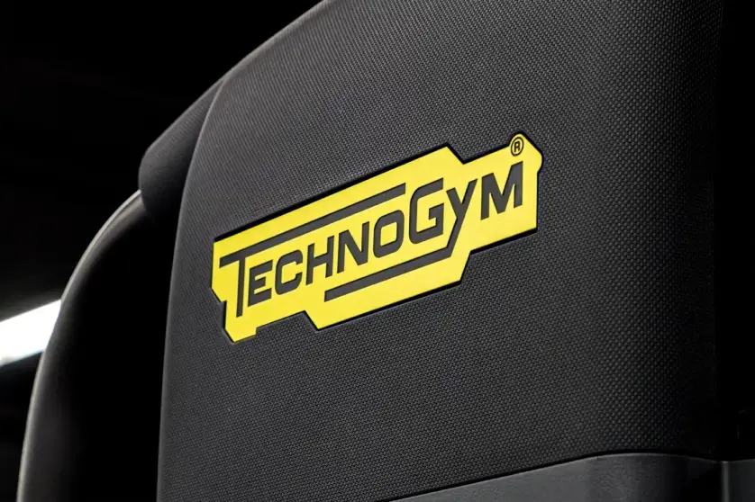 Close-up of a Technogym fitness equipment seat, highlighting the premium gym equipment available to residents.