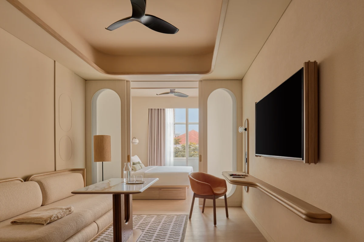 "Stamford Premier Suite living area with arched doorways looking through to the bedroom and city view at APT.