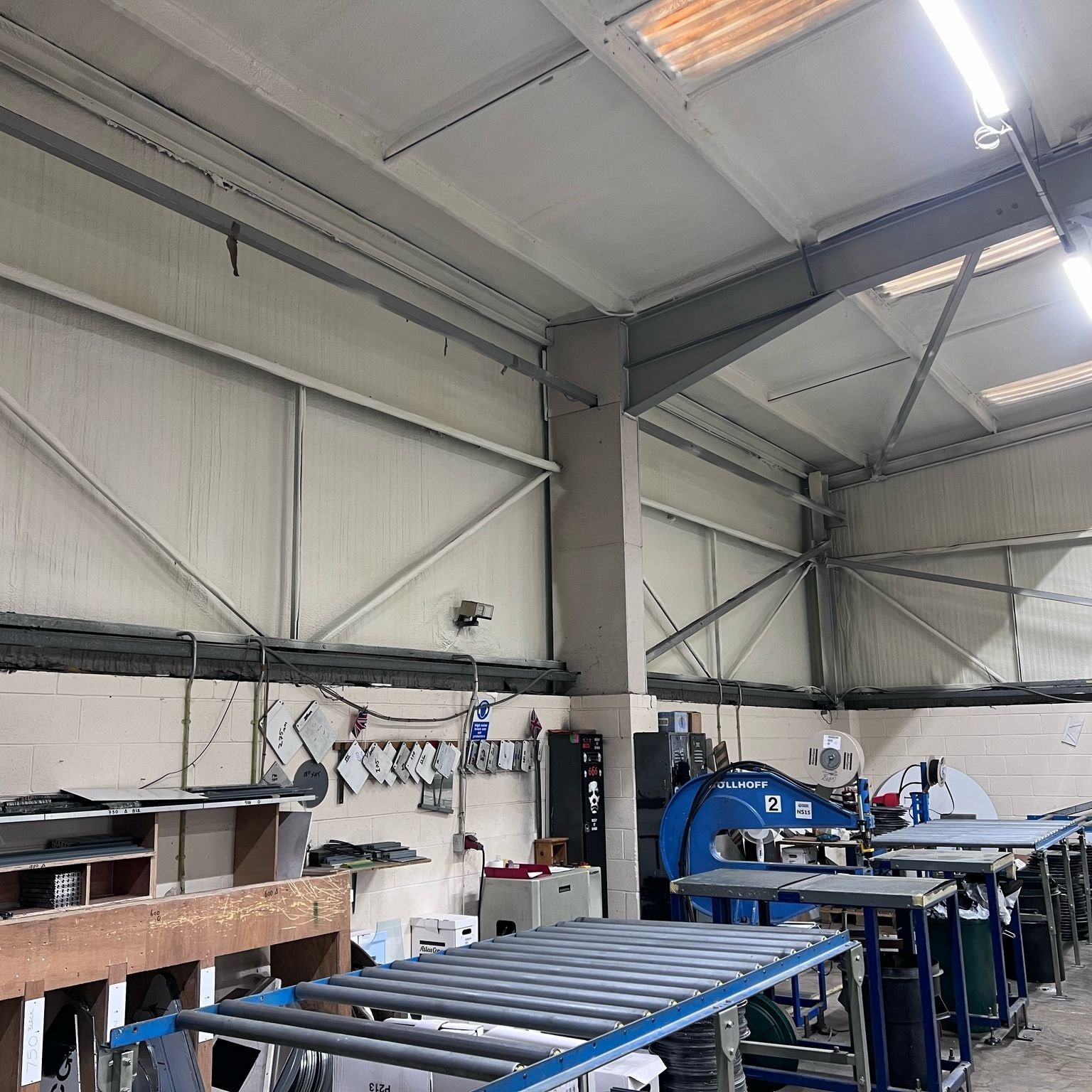 After: the finished factory roof, one continuous layer across the production floor.