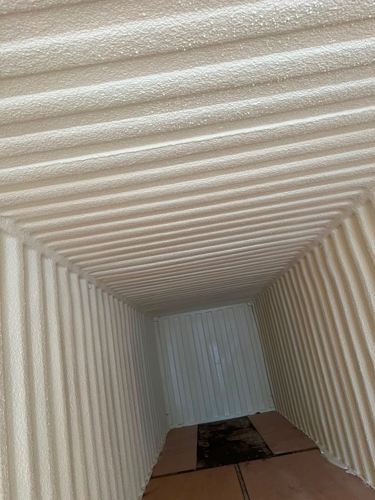 Inside the treated storage container at The Regis School: walls and ceiling in a continuous closed-cell layer.