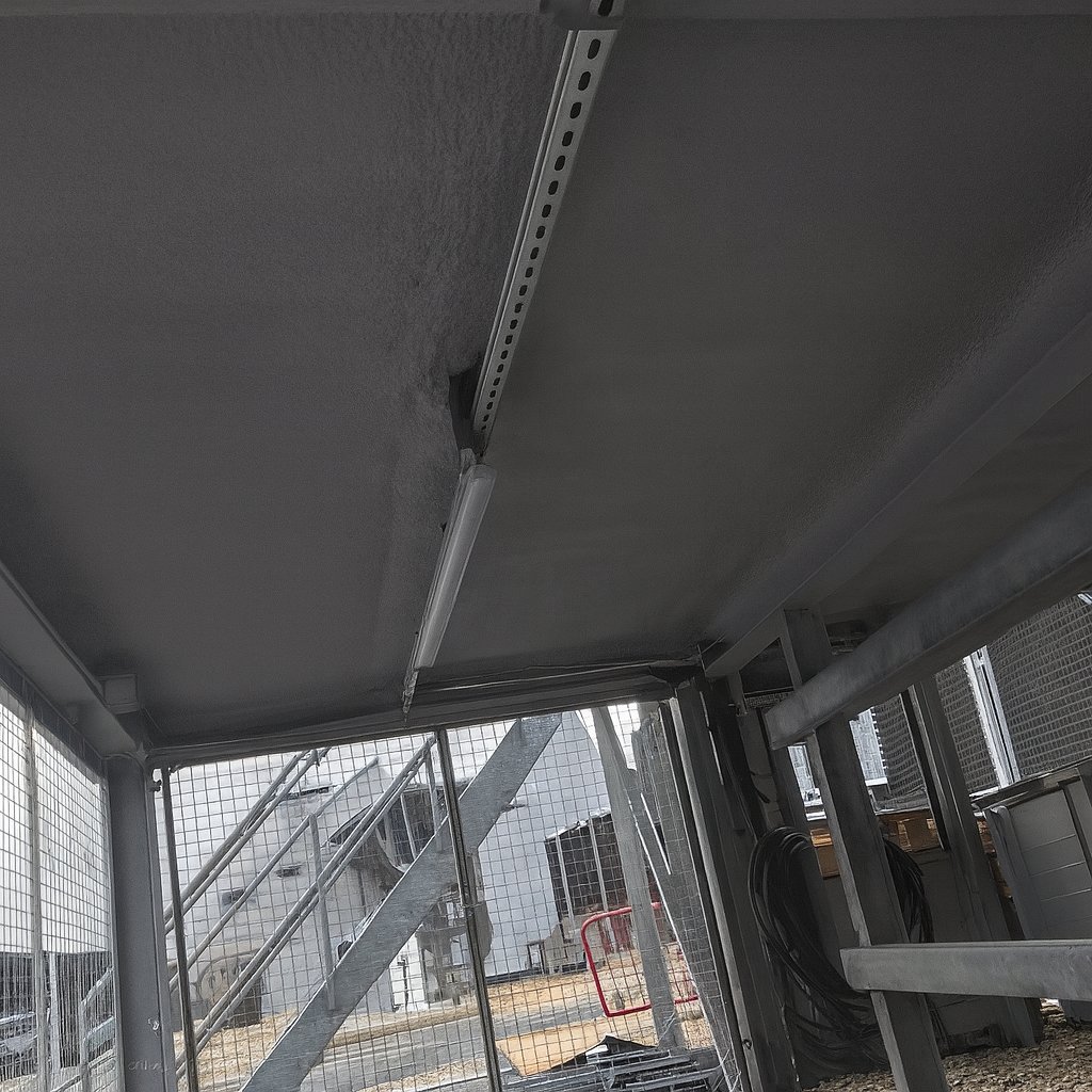 The substation undercroft after the work: the soffit and beams in an ice-grey coated finish.