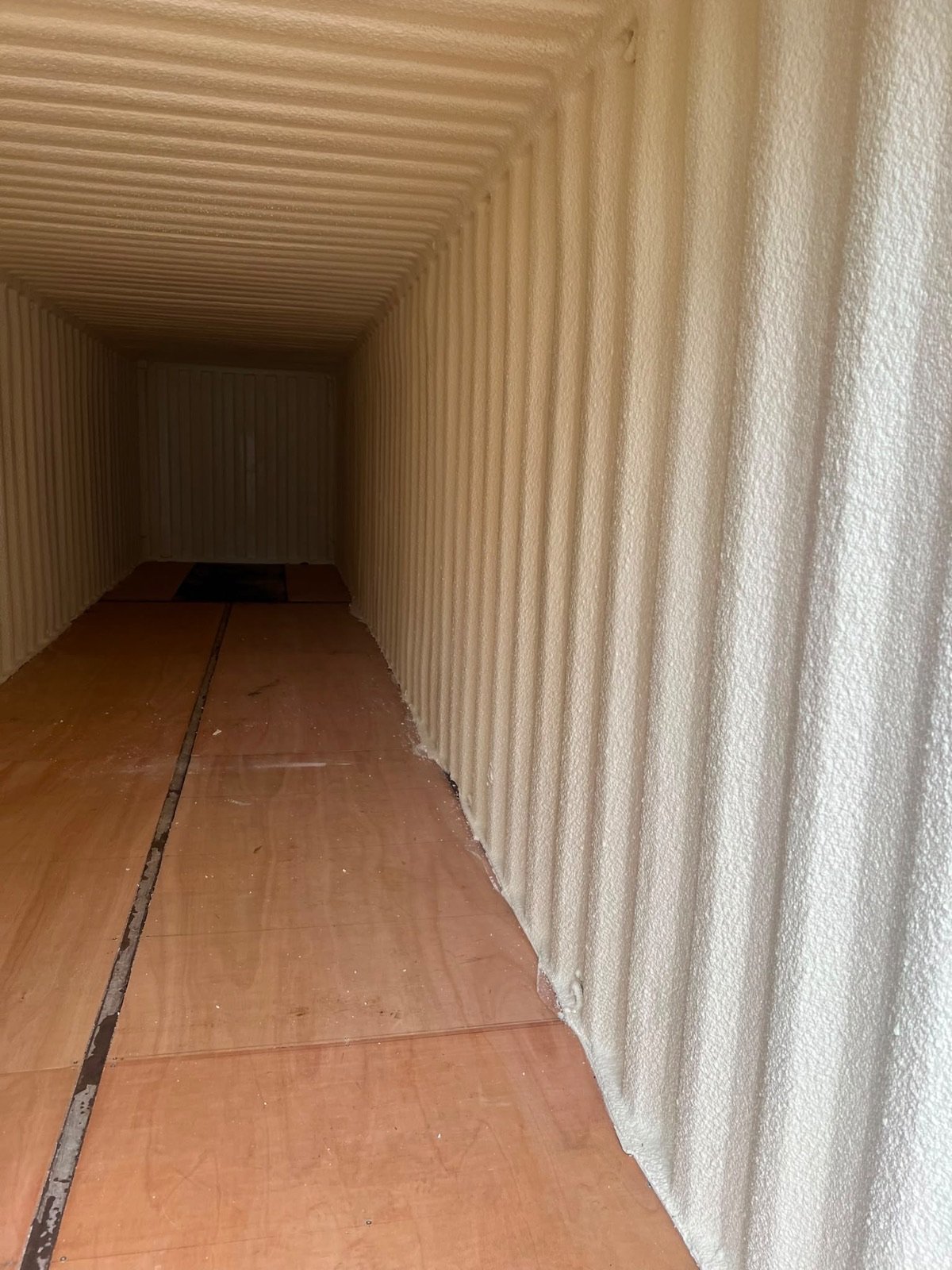 During: closed-cell foam on the corrugated wall, following each rib of the steel.