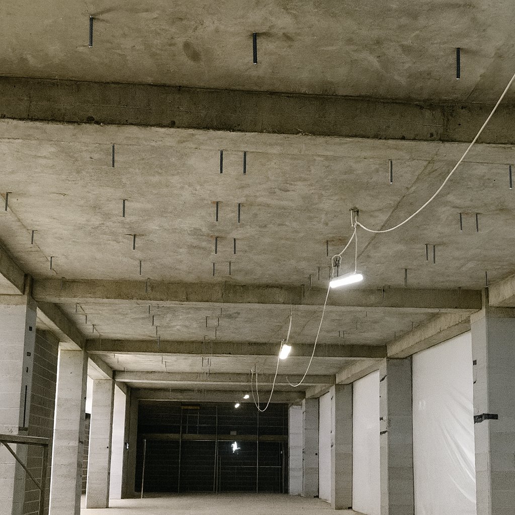Before: the exposed concrete soffit at The Box, beams and service penetrations bare.