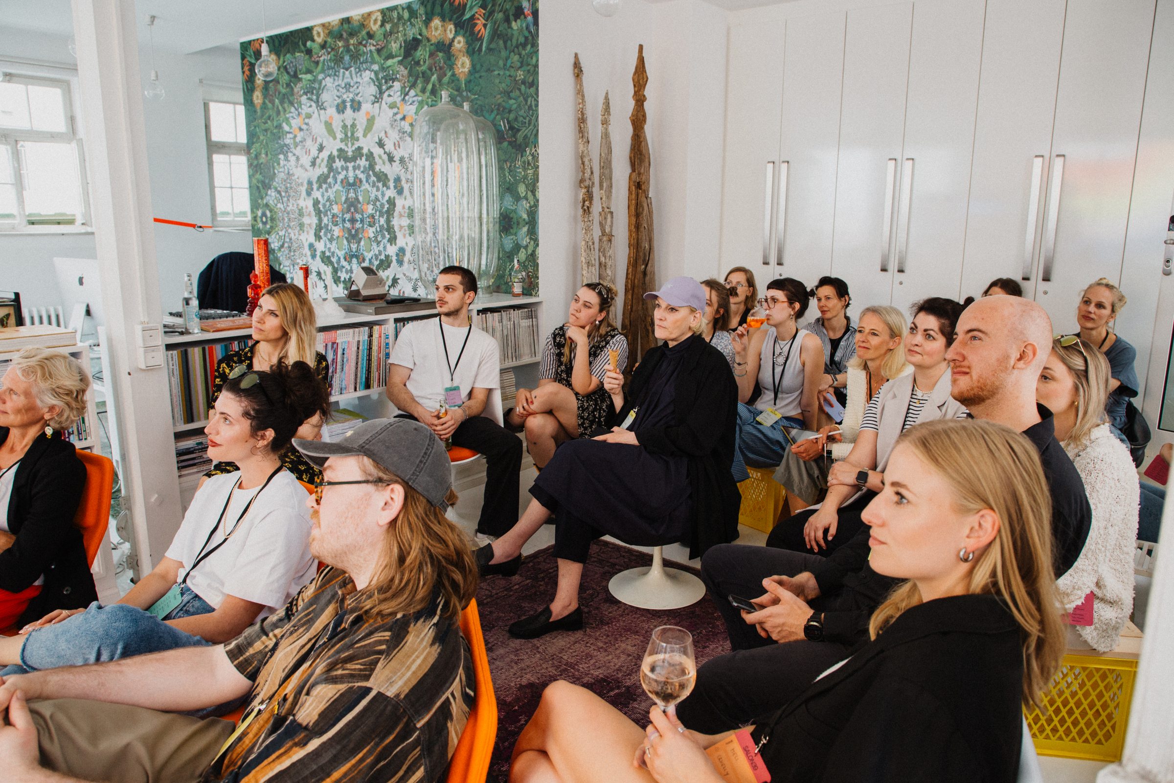 Attendees listen to a talk in a cozy living-room-style setting at Salon39.