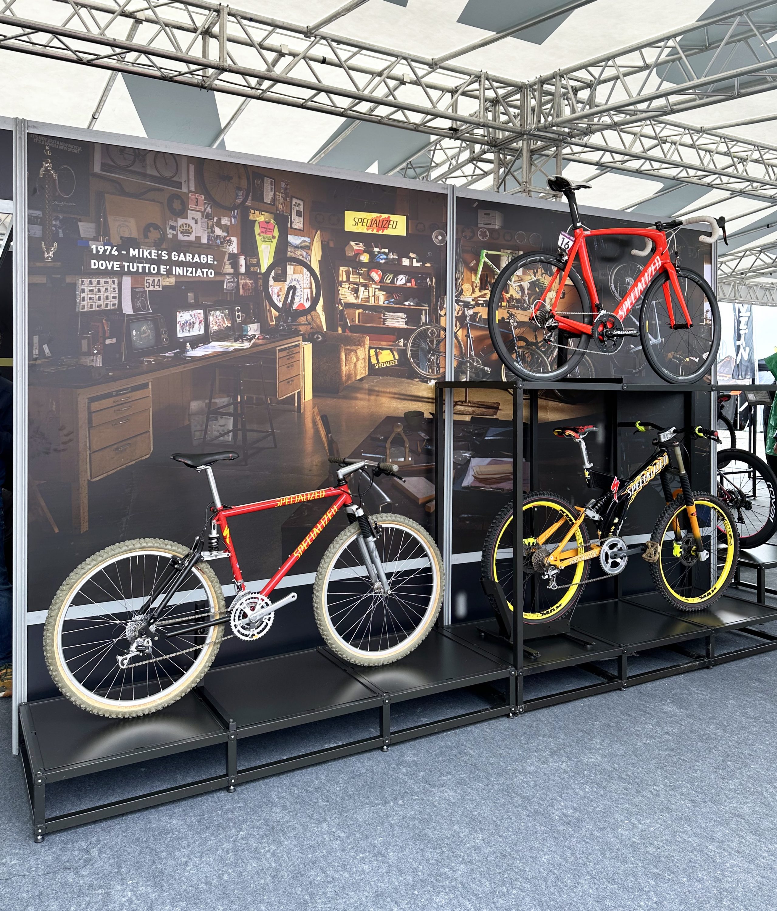 Specialized-Stand mit Vintage-Werkstattkulisse und historischen Mountainbikes