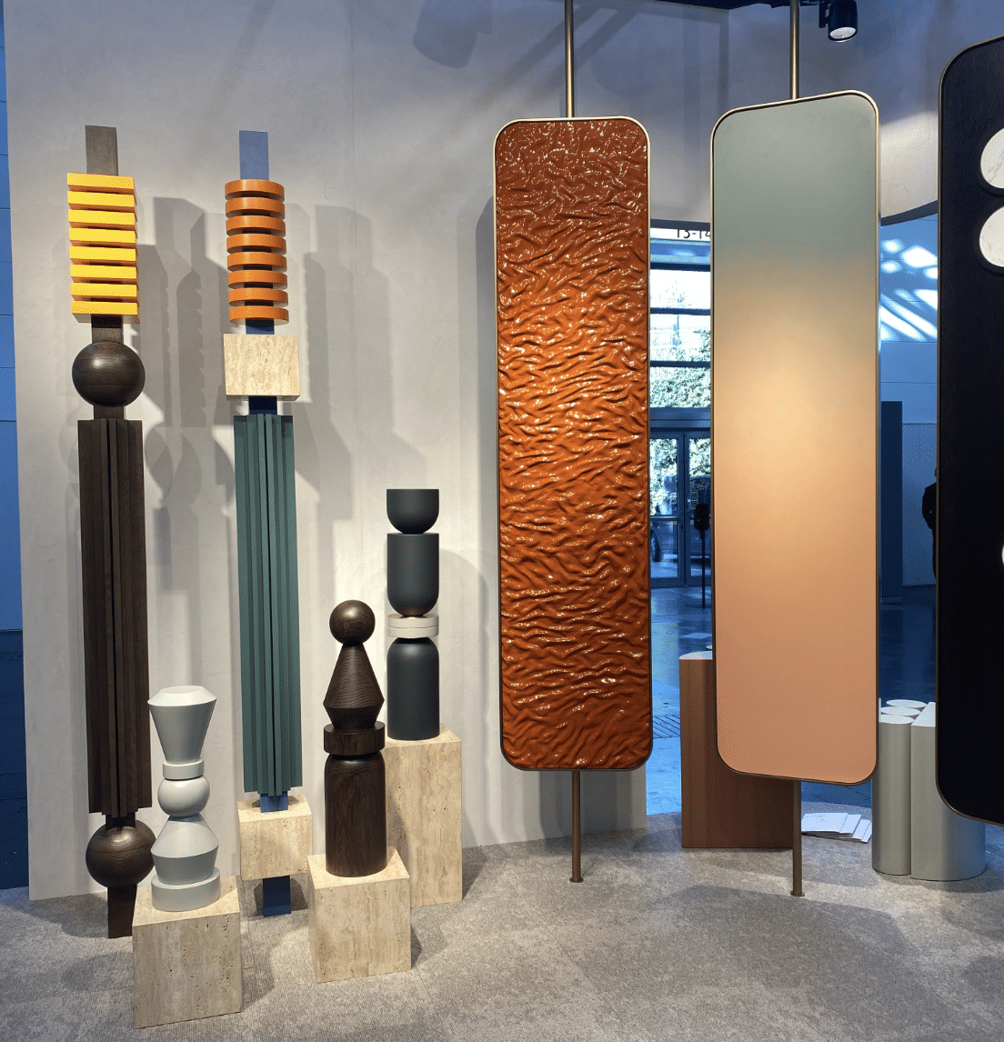 Sculptural retail display pieces and mirror panels shown at an EuroShop 2023 exhibition stand.