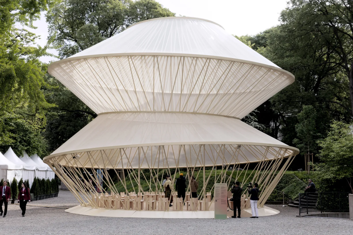 Uzbekistan's “When Apricots Blossom” pavilion: white tensile tent structure with bamboo struts in the park
