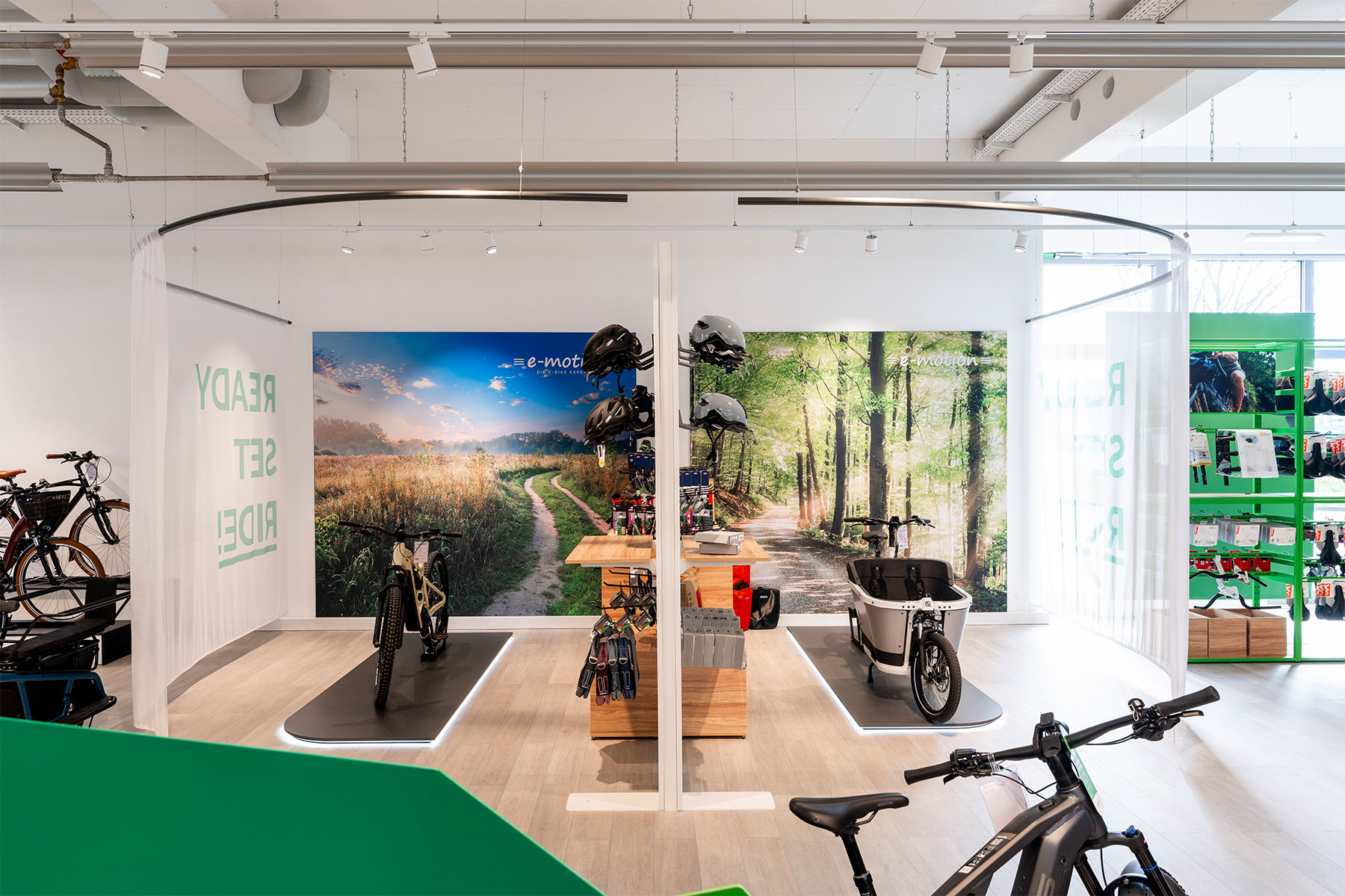 Round "Ready Set Ride" experience module with landscape imagery, helmets and e-bikes